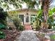 Charming single-story home featuring lush tropical landscaping and a welcoming front porch at 803 E Amelia St, Orlando, FL 32803