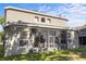 Home featuring an enclosed screened patio and a well-maintained backyard, perfect for outdoor living and entertaining at 9244 Pecky Cypress Way, Orlando, FL 32836