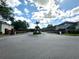 Gated community entrance with brick pillars, black metal gates, and manicured landscaping provides security and curb appeal at 9244 Pecky Cypress Way, Orlando, FL 32836