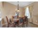 Cozy dining room featuring a glass-top table, upholstered chairs, and a Tiffany-style pendant light at 9244 Pecky Cypress Way, Orlando, FL 32836