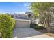 Two-story home with a neutral color scheme, complemented by a well-maintained lawn, mature trees, and a two car garage at 9244 Pecky Cypress Way, Orlando, FL 32836