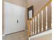 Inviting foyer with a white front door, a staircase with wooden banisters, and tile flooring at 9244 Pecky Cypress Way, Orlando, FL 32836
