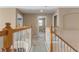 Upstairs hallway featuring a carpeted floor and wooden railing at 9244 Pecky Cypress Way, Orlando, FL 32836