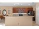 Open kitchen with dark cabinetry, light countertops, and stainless steel appliances offers ample counter space at 9244 Pecky Cypress Way, Orlando, FL 32836