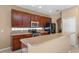 Stylish kitchen featuring dark wood cabinetry, stainless appliances, and a functional breakfast bar at 9244 Pecky Cypress Way, Orlando, FL 32836