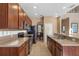 Spacious kitchen with ample counter space, stainless steel appliances, and a view into the dining area at 9244 Pecky Cypress Way, Orlando, FL 32836