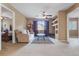 Cozy living room with ample sunlight, comfortable seating, and modern ceiling fan at 9244 Pecky Cypress Way, Orlando, FL 32836