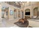 Bright living room with high ceilings, tile floors, and a decorative coffee table at 9244 Pecky Cypress Way, Orlando, FL 32836