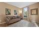 Comfortable living room with a plush sofa, decorative pillows, and a large window with elegant curtains at 9244 Pecky Cypress Way, Orlando, FL 32836