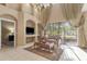 Bright living room with high ceilings, a large window, and an adjacent seating area at 9244 Pecky Cypress Way, Orlando, FL 32836