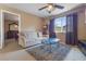 Cozy living room with ample sunlight, comfortable seating, and modern ceiling fan at 9244 Pecky Cypress Way, Orlando, FL 32836