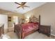 Comfortable bedroom with a wrought iron bed frame and a view into the bathroom at 9244 Pecky Cypress Way, Orlando, FL 32836