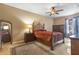 Bedroom with a decorative iron bed frame, side table, and neutral color palette at 9244 Pecky Cypress Way, Orlando, FL 32836