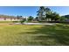 Well-maintained community playground featuring play equipment and a grassy area at 9244 Pecky Cypress Way, Orlando, FL 32836