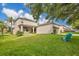 A well-maintained backyard with lush green grass, patio furniture, and a view of the home at 987 Alston Bay Blvd, Apopka, FL 32703