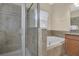 Bathroom features a bathtub, separate shower with glass doors, and tiled walls at 987 Alston Bay Blvd, Apopka, FL 32703