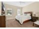 Comfortable bedroom featuring carpet floors, two windows, and ceiling fan at 987 Alston Bay Blvd, Apopka, FL 32703