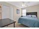 This bedroom features a closet with a ceiling fan and a comfortable blue bed at 987 Alston Bay Blvd, Apopka, FL 32703