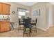 Cozy breakfast nook with a round table, four chairs, and natural light from the window at 987 Alston Bay Blvd, Apopka, FL 32703