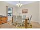 Bright dining room featuring a glass table, seating for six, and a window with natural light at 987 Alston Bay Blvd, Apopka, FL 32703