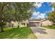 This home boasts a spacious lawn, wide driveway, and comfortable backyard seating at 987 Alston Bay Blvd, Apopka, FL 32703