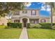 Charming two-story home features a well-manicured lawn, red shutters, and a welcoming front porch at 987 Alston Bay Blvd, Apopka, FL 32703