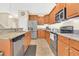 This well-lit kitchen features wood cabinets, stainless steel appliances and granite countertops at 987 Alston Bay Blvd, Apopka, FL 32703