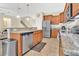 Well-lit kitchen features granite countertops, stainless steel appliances, and wood cabinets at 987 Alston Bay Blvd, Apopka, FL 32703