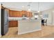 Spacious kitchen with granite countertops, stainless steel appliances, and a breakfast bar at 987 Alston Bay Blvd, Apopka, FL 32703