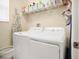 The functional laundry room features appliances and shelving units for ample storage at 987 Alston Bay Blvd, Apopka, FL 32703