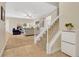 Bright, open living space featuring neutral carpet, a staircase, and comfortable seating at 987 Alston Bay Blvd, Apopka, FL 32703
