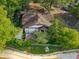 Aerial view of a charming Tudor-style home, complemented by mature trees and a well-maintained landscape at 1000 E Anderson St, Orlando, FL 32801