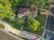 Aerial perspective of Tudor-style home, showcasing its mature trees, sidewalk, and well-kept landscaping at 1000 E Anderson St, Orlando, FL 32801