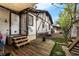 Back of house featuring Tudor detailing, wooden deck, stairs and small yard with trees at 1000 E Anderson St, Orlando, FL 32801