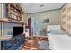 Bedroom featuring hardwood floors, bright windows, wallpaper, and built-in shelving at 1000 E Anderson St, Orlando, FL 32801