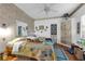 Bright bedroom featuring hardwood floors, ceiling fan, and an antique-style wardrobe for plenty of storage at 1000 E Anderson St, Orlando, FL 32801