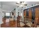 Dining area open to the living room, with a glass-top table and decorative cabinets for storage at 1000 E Anderson St, Orlando, FL 32801