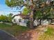 Charming Tudor-style home with mature landscaping and a detached garage, showcasing curb appeal at 1000 E Anderson St, Orlando, FL 32801
