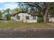 Charming Tudor-style house with brick-paved road and surrounding trees at 1000 E Anderson St, Orlando, FL 32801