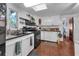 Efficient kitchen featuring white cabinets, a gas range, and updated fixtures for practical cooking at 1000 E Anderson St, Orlando, FL 32801