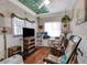 Living room featuring hardwood floors, bright windows, and several rocking chairs at 1000 E Anderson St, Orlando, FL 32801