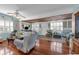 Spacious living room with a ceiling fan, plantation shutters, and tile flooring creating an inviting ambiance at 1000 E Anderson St, Orlando, FL 32801