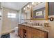 Bathroom featuring a double vanity with granite countertops and a tiled glass door shower at 10119 Bayard Ct, Orlando, FL 32836