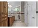 Bright bathroom featuring a double vanity, walk-in shower, and storage cabinets at 10119 Bayard Ct, Orlando, FL 32836