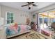 Cheerful bedroom with a ceiling fan and sliding glass doors to the lanai at 10119 Bayard Ct, Orlando, FL 32836