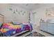 Charming bedroom featuring rainbow bedding, decor and tile floors at 10119 Bayard Ct, Orlando, FL 32836