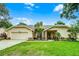 Charming single-story home featuring manicured lawn, two-car garage, and beautiful landscaping at 10119 Bayard Ct, Orlando, FL 32836