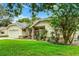 Side view of a single-story home with a well-manicured lawn and mature landscaping at 10119 Bayard Ct, Orlando, FL 32836