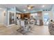 Bright and modern kitchen featuring a central island with seating, stainless steel appliances, and tile floors at 10119 Bayard Ct, Orlando, FL 32836