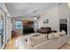 Bright living room featuring hardwood floors, large windows, and comfortable seating at 10119 Bayard Ct, Orlando, FL 32836